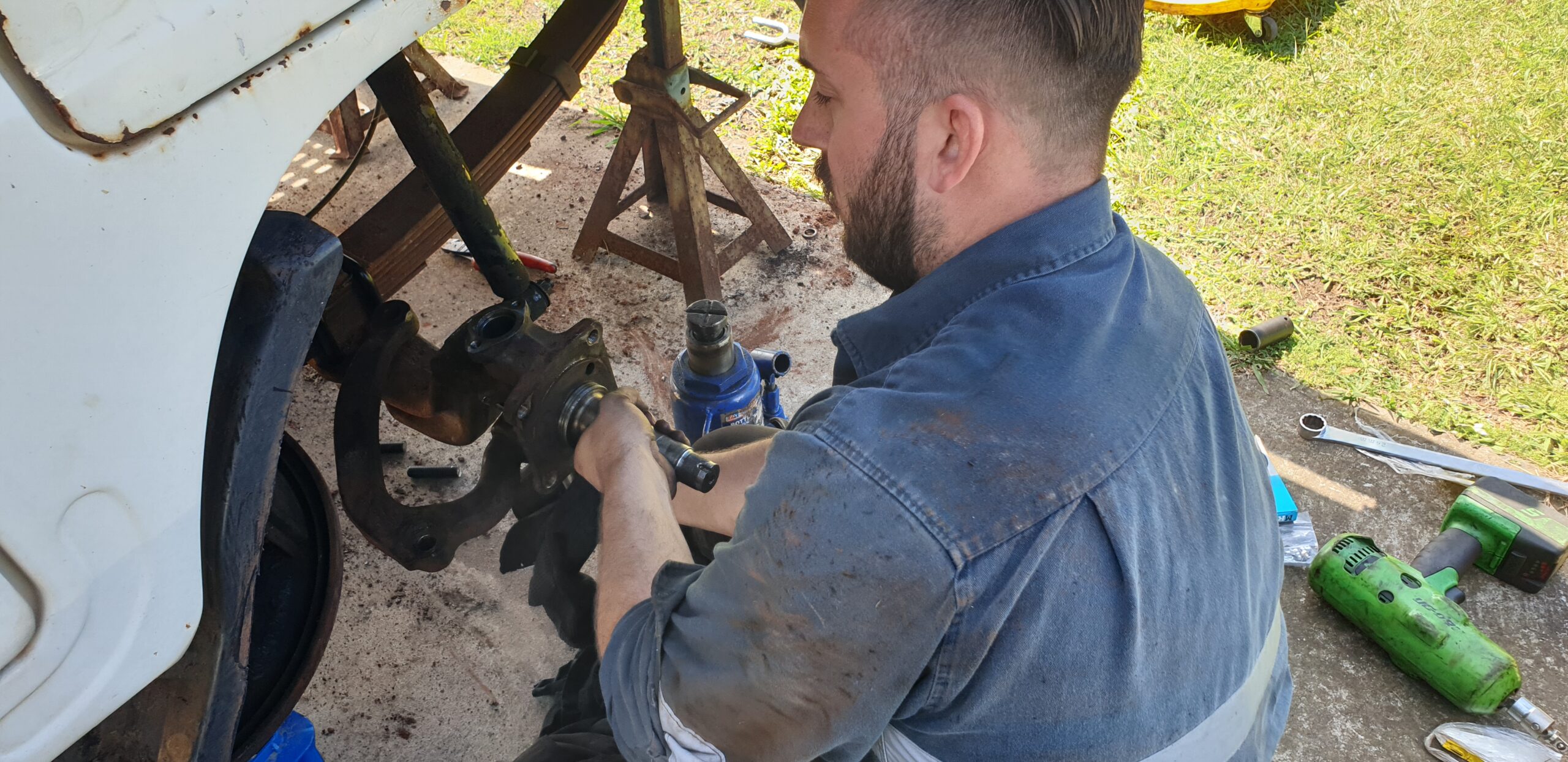 Truck mechanic fixing kingpin